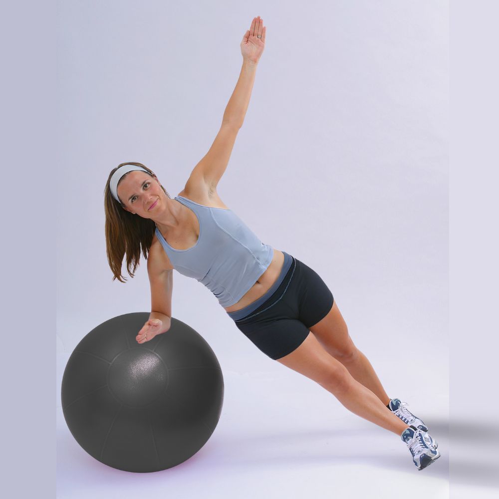 Woman exercising with professional exercise ball in size 55cm, burst resistant to 500lbs, professional grade stability ball