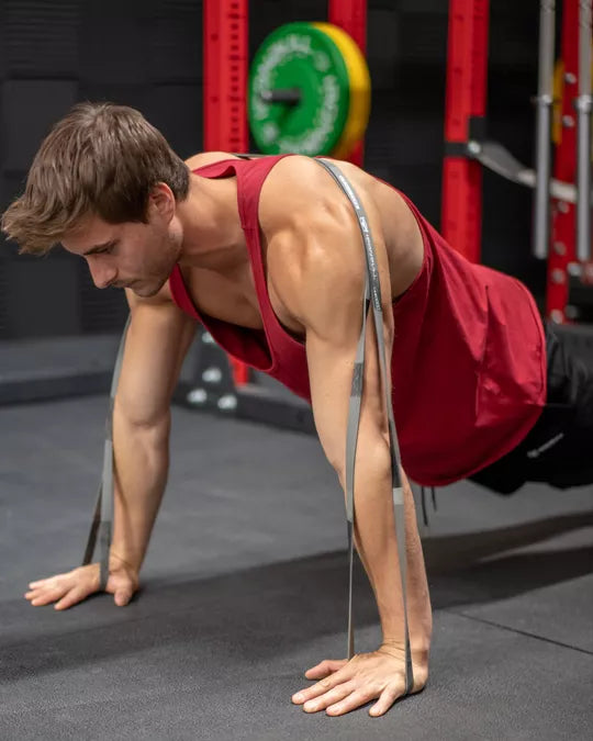 performing a push-up with latex free resistance bands, ships from Calgary Alberta Canada